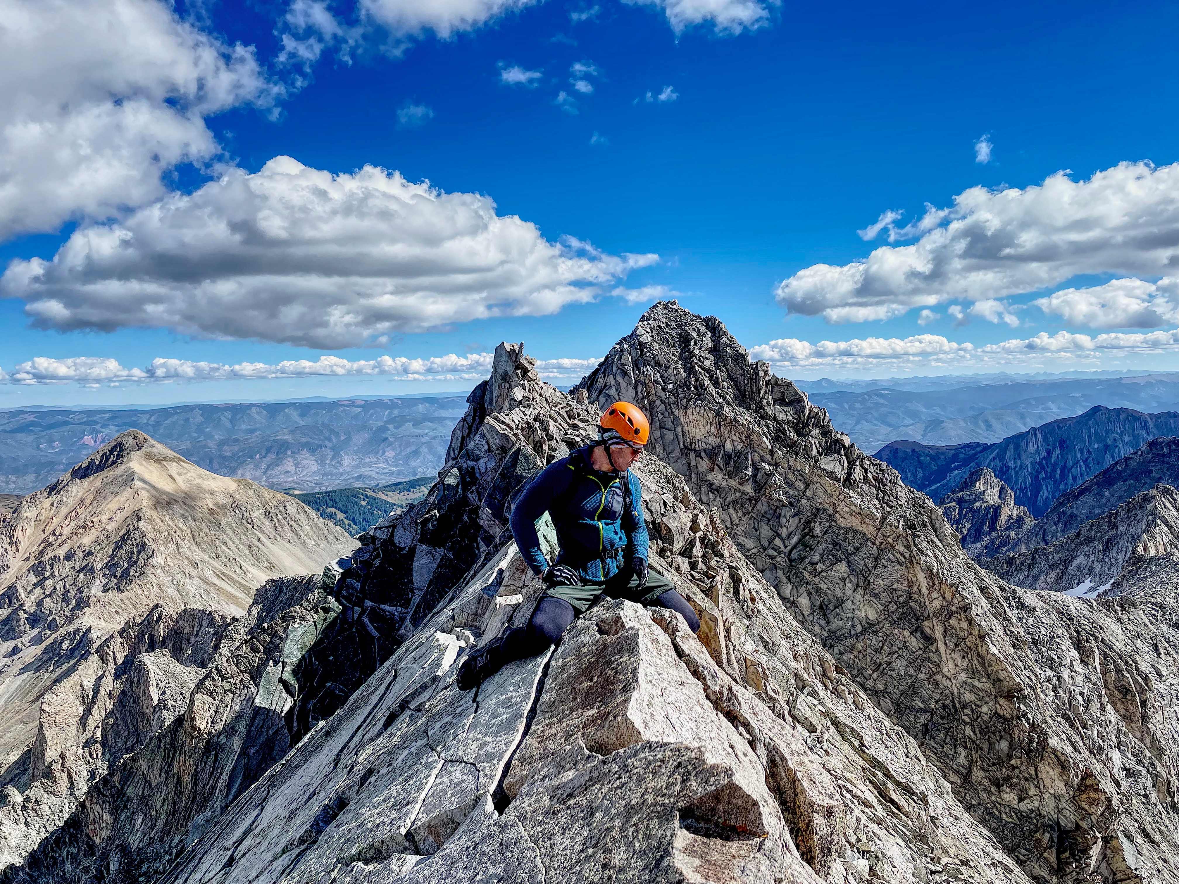 Mountaineer climbing a rugged alpine ridge